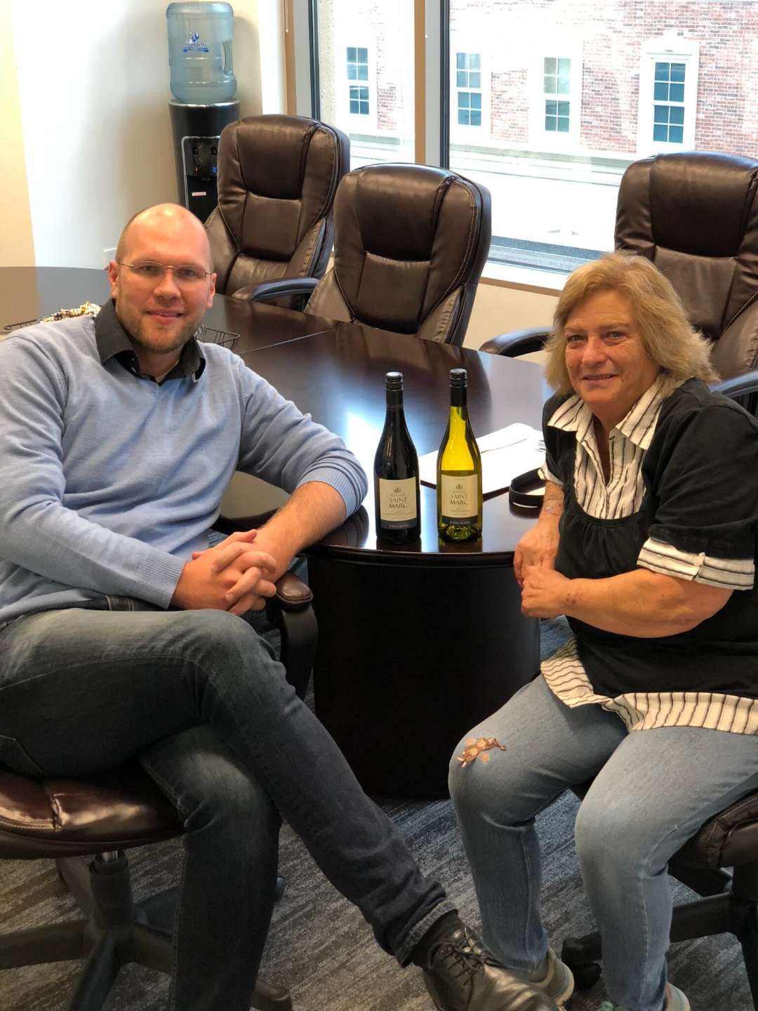 Ronnie from I-96 Home Buyers with a happy seller after closing